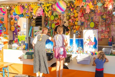 Children and adults play at a colourful stand at a fair, 950 years Weil der Stadt ceremony,