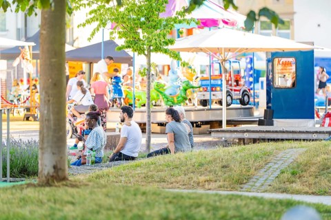 People enjoying a sunny day in the park with activities and carousel, 950 years Weil der Stadt