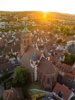 Picturesque view of a church and town at sunset with historical buildings and roof landscapes, 950