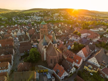 A bird's eye view of the evening cityscape with church at sunset, 950 years Weil der Stadt