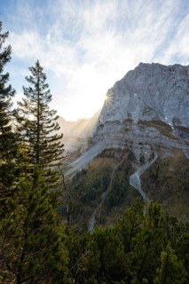 Mountain landscape in autumn, sun star in the morning light, rocky mountain peak of the