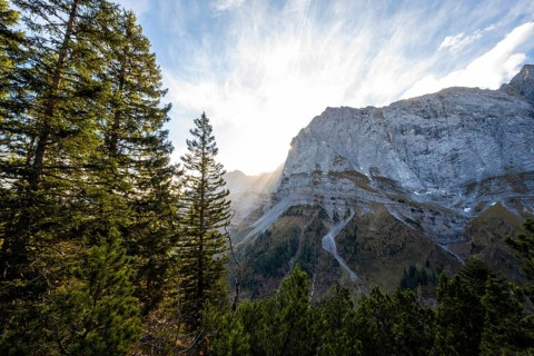 Mountain landscape in autumn, sun star in the morning light, rocky mountain peak of the