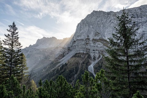 Sunbeams fall over a rocky mountain ridge, Mountain landscape in autumn in the morning light, Rocky
