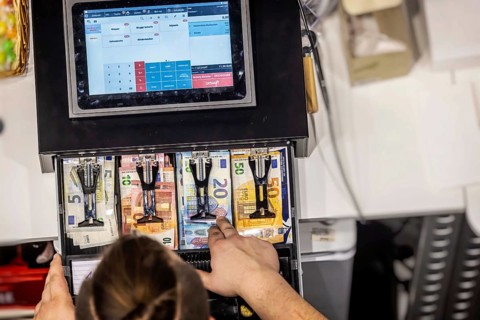 Restaurant cash register. Cash register with display and banknotes in the catering trade.