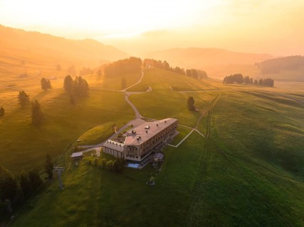 Architectural building on a hill with evening light and peaceful atmosphere, Alpe di Siusi,