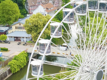 Ferris wheel overlooking a river and surrounding village landscape in the countryside, Ferris wheel