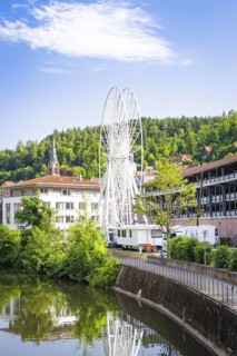 Ferris wheel in an urban environment with church and river in the background, Ferris wheel