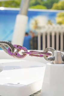 Close-up of a metal connection in front of a blurred background in pastel colours, Ferris wheel