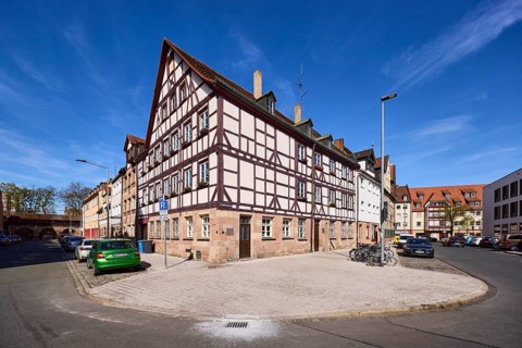 Old town, half-timbered house, general architecture, lantern, parking lane with vehicles, blue sky,