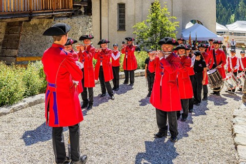 Pipers and drummers line up for the Corpus Christi procession, historic village centre, Grimentz,