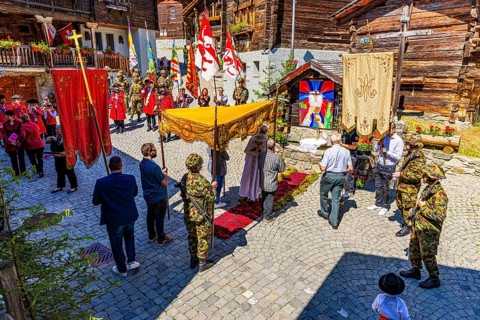 The priest celebrates a service at the flower-decorated altar during the Corpus Christi procession,