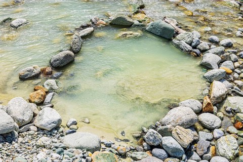 Boulders form a circle in the mountain stream La Navisence, near Zinal, Val d'Anniviers, Valais