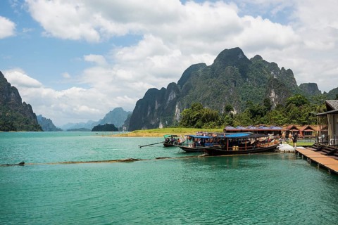 Floating houses on lake with jungle and rainforest and steep mountains, Cheow Lan Lake, Khao Sok