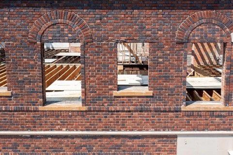 Detroit, Michigan - Workers rehab a long-vacant and crumbling commercial building in the