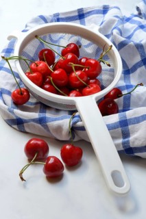 Sweet cherries in sieve, Prunus avium, bird cherry