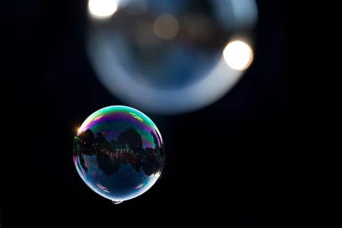 Two shimmering and floating soap bubbles against a black background, Recklinghausen, North