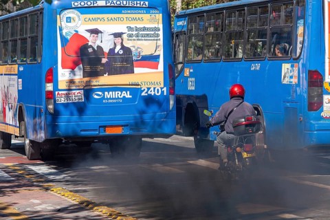 Buses in motion emitting pollution, City of Quito. Pichincha province, Ecuador, South America