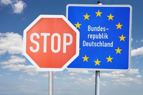 (Photomontage) Stop sign in front of a border sign of the Federal Republic of Germany