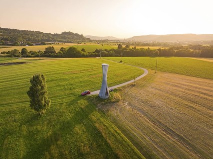 Panorama of a green landscape with a modern observation tower in the sun