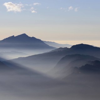 Mountain silhouettes... Alpine peaks and mountain ranges in the Bavarian Alps, light fog rises from