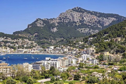 View at the idyllic coast village Port de Soller a famous tourist resort with houses around the