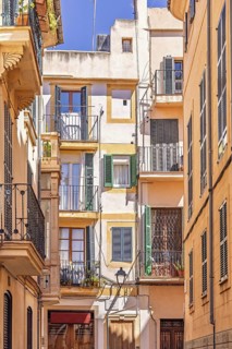 Residential building with balconies at the flats in a narrow alley in the old town at Palma de