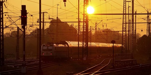 Travelling train at sunrise, Central Station, Dortmund, Ruhr Area, Germany