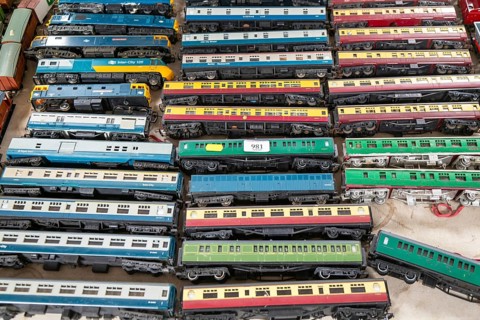 Model railway toy train set items on display for sale at auction room, UK