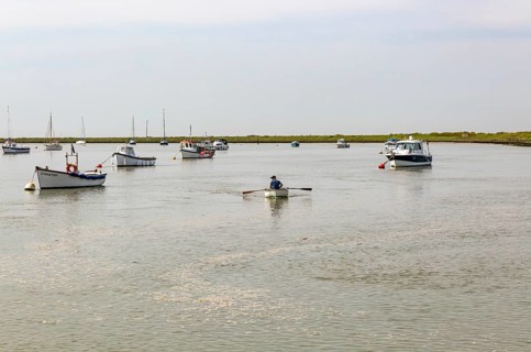Boats at moorings on River Ore, Orford, Suffolk, England, UK