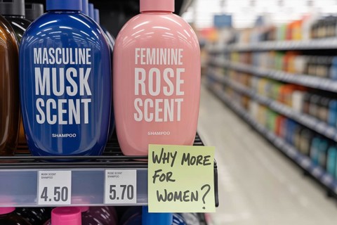 Pink tax concept shpwing two gendered shampoo bottles priced differently. Blue masculine and pink