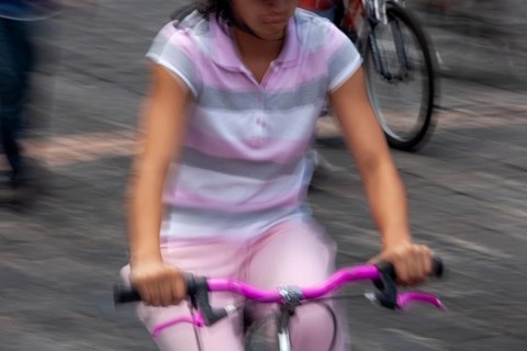 Woman riding a bicycle, Photo with motion blur, City of Quito, Pichincha province, Ecuador, South