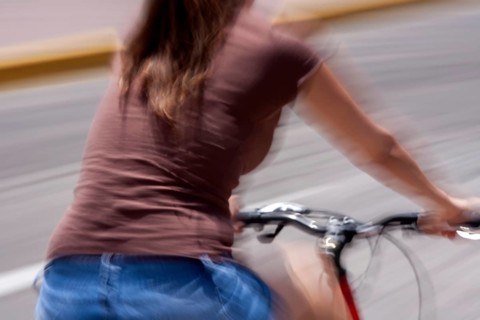 Woman riding a bicycle, Photo with motion blur, City of Quito, Pichincha province, Ecuador, South