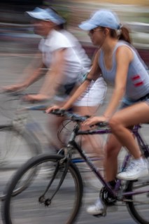 Women riding on bicycles, Photo with motion blur, City of Quito, Pichincha province, Ecuador, South