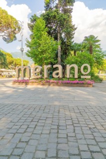 Large lettering 'Merano' in a park decorated with flowers, Merano, Italy