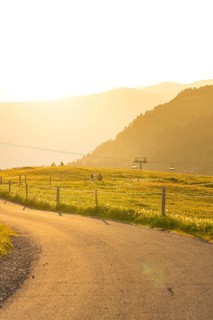 Landscape with rolling hills, a meadow and a cable car at sunset, Alpe di Siusi, Dolomites, South
