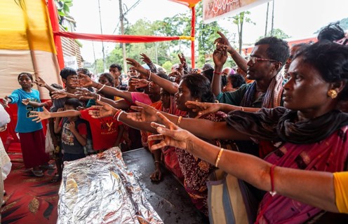 Devotees throng to have food as they arrives to visit Kamakhya Temple during Ambubachi Mela, in