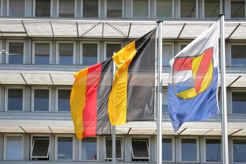 Three flags at the job centre, modern building with window, national flag, Baden-Württemberg state