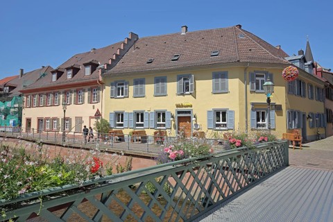 Half-timbered houses on the Alb, pedestrian bridge with bridge railing and floral decoration,