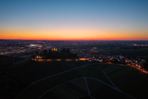 Expansive city view at dusk, with illuminated chapel and vineyards, grave chapel, Zum Württemberg,