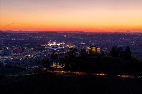 Panoramic view of an illuminated town and chapel at sunset, grave chapel, spring festival, Zum