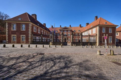 Episcopal Vicariate General, vicariate, brick building, bollards, cobblestone pavement, blue