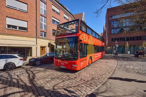The Münsterbus, bus for city tours, tourism, general architecture, cobblestone street, blue