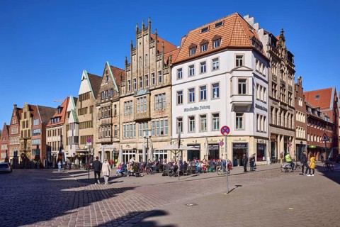 Old town, historical buildings, outdoor area of a restaurant, pedestrians as secondary motif, blue