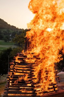 Sunset at a midsummer fire in Germany, Swabian Alb, Lenninger Tal, June 2025, firefighter in the
