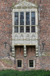 A richly decorated Gothic bay window on an old brick wall, Raesfeld moated castle, Münsterland,