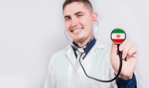 Doctor showing stethoscope with Iran flag. Iran national healthcare concept