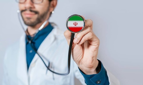 Doctor holding stethoscope with Iran flag. Iran health and care concept, Iran flag on stethoscope