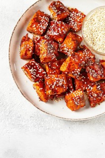 Fried pieces of salmon teriyaki with sesame seeds, top view