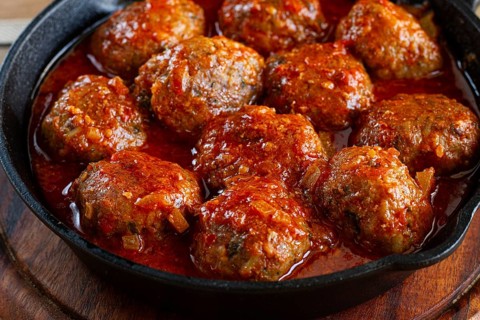 Minced meat meatballs, in tomato sauce, in a cast-iron pan, homemade, no people
