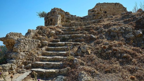 Dilapidated stone steps in an arid landscape dotted with ruins, Antimacheia, Medieval fortress, St